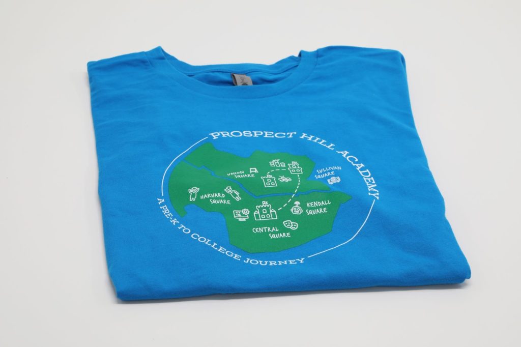 Promotional Apparel PROSPECTHILL_Tshirt1 A blue t-shirt with the prospect hill logo design created by Fenway Group