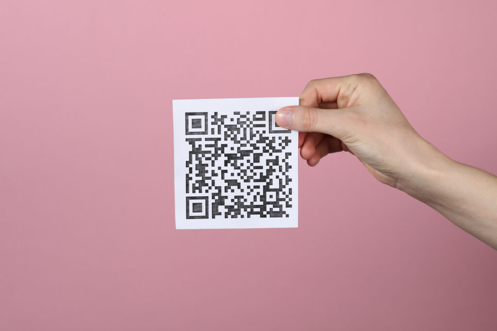 A person holding a QR code.