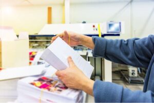 A person preparing a direct mail campaign.