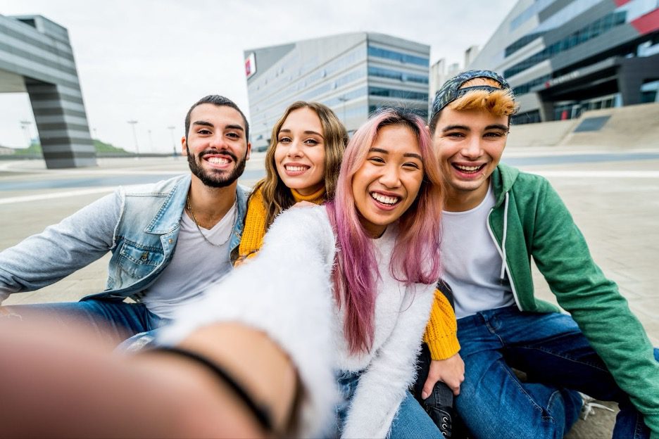 A group of Gen-Z young adults taking a selfie.